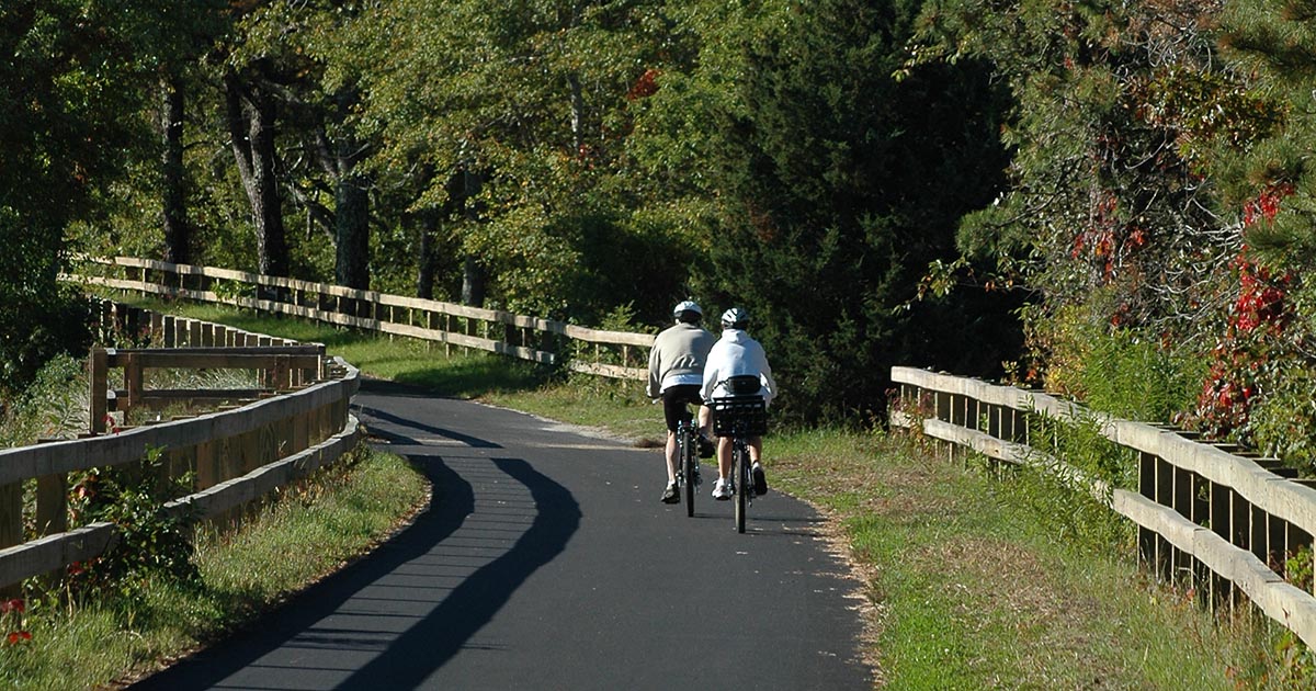 two people riding bikes on Cape Cod